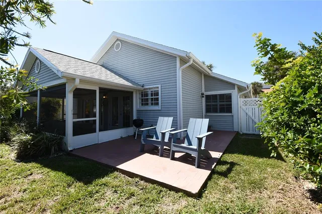 a view of a house with backyard sitting area and garden