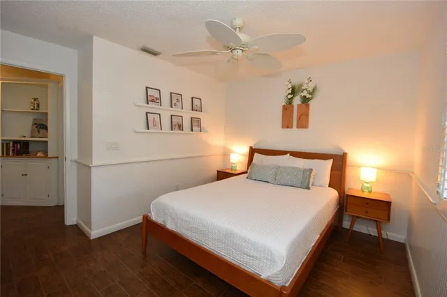 a large bed sitting in a bedroom next to a window