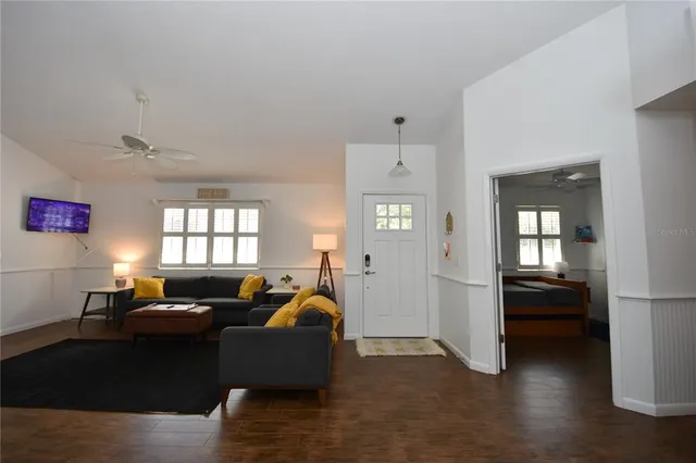 a living room with furniture and wooden floor