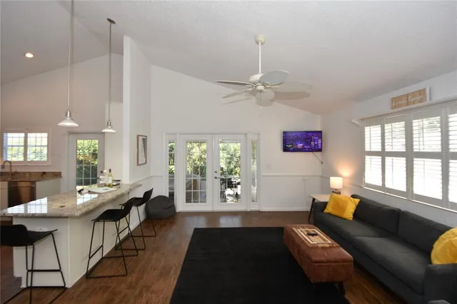 a living room with furniture and a chandelier