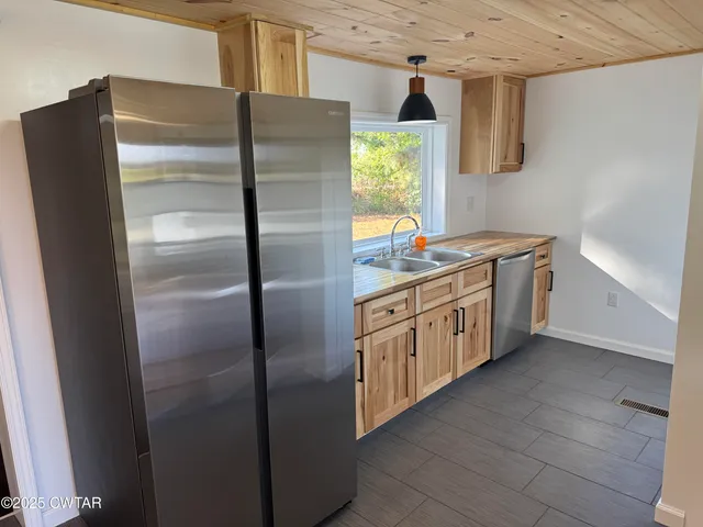 a kitchen with stainless steel appliances granite countertop a stove and a microwave