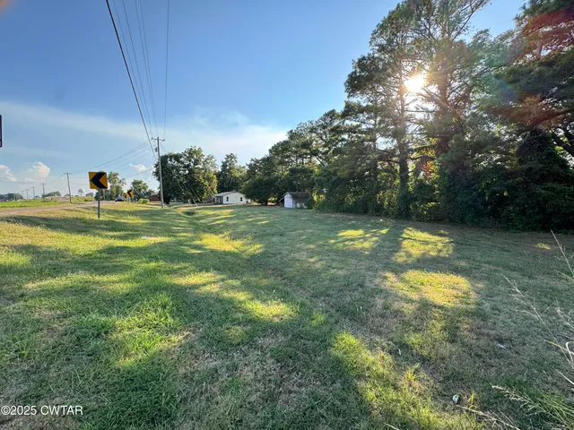 a swimming pool with an outdoor space and seating area