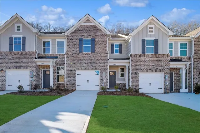 a front view of a house with a garden and plants