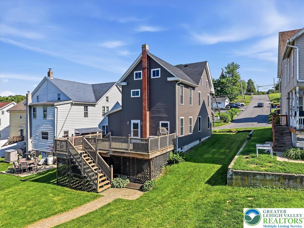 3453 Main Street Slatington, PA 18080 - Photo 2 of 30 A well-maintained lawn stretches toward a home featuring a spacious outdoor deck for relaxation and entertaining.