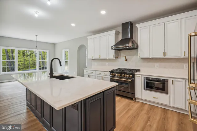 a kitchen with a stove a sink and a refrigerator