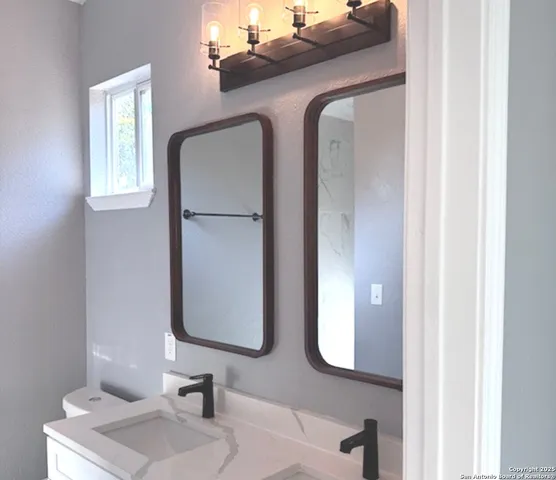 a bathroom with a sink and a mirror