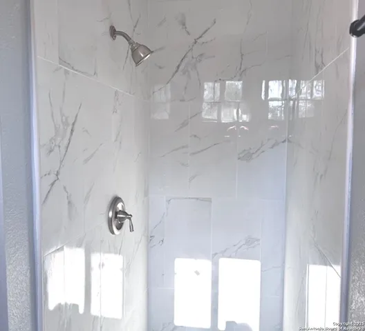 a bathroom with a bathtub and shower