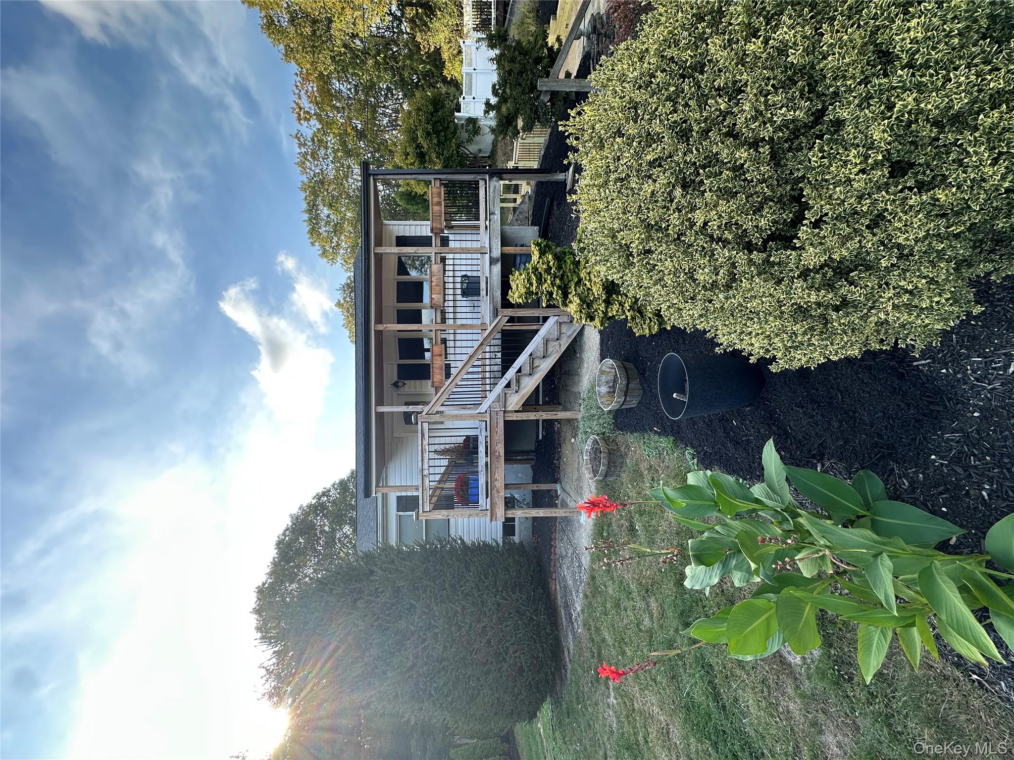 a backyard of a house with yard table and chairs
