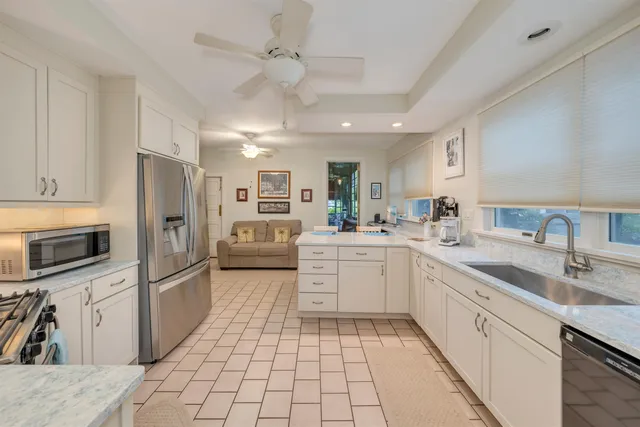 a living room with furniture a dining table and kitchen view