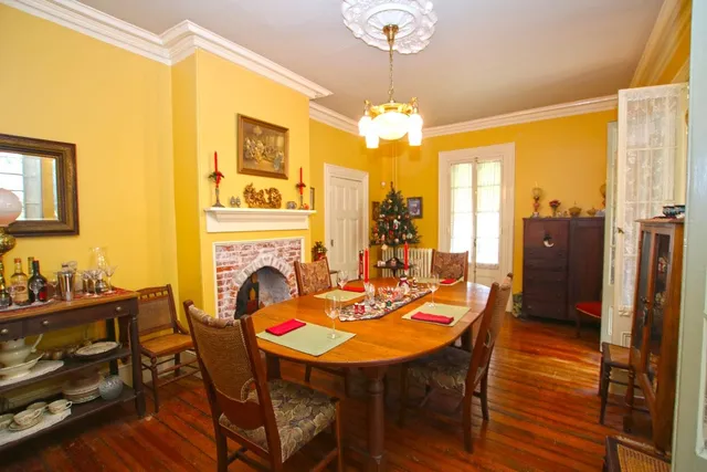 a living room with furniture a fireplace and a chandelier