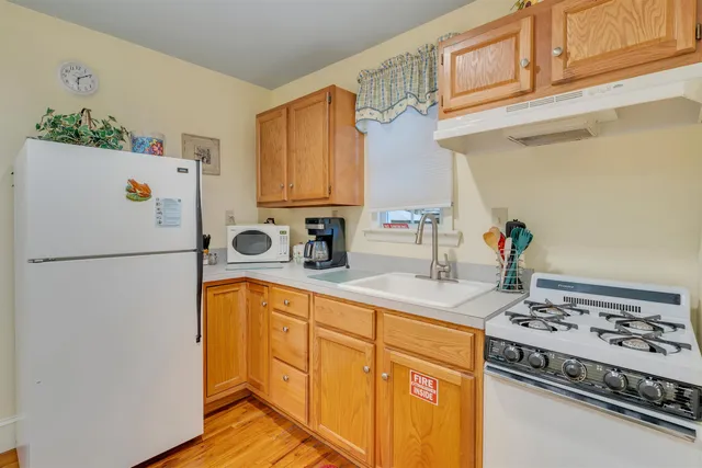 a bedroom with a bed and large windows