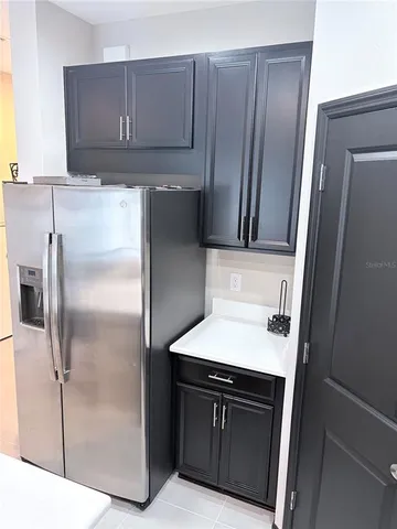 a kitchen with a refrigerator sink and cabinets