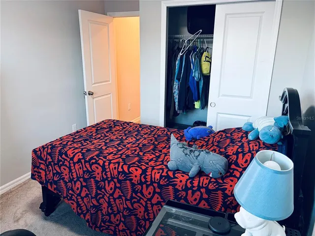a bedroom with a bed and a chair