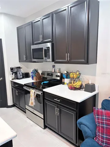 a kitchen with stainless steel appliances granite countertop a sink and a stove