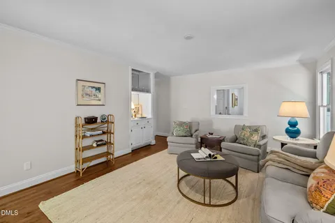 a living room with furniture a fireplace and a large window