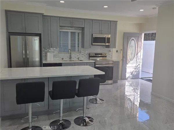 a living room with furniture and kitchen view