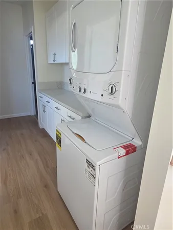 a kitchen with white cabinets and sink