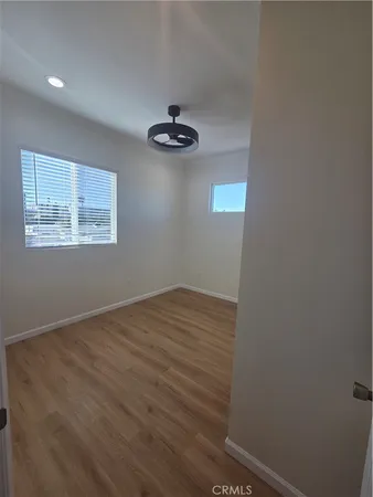 an empty room with a empty space and wooden floor