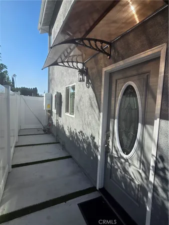 a view of a house with wooden fence