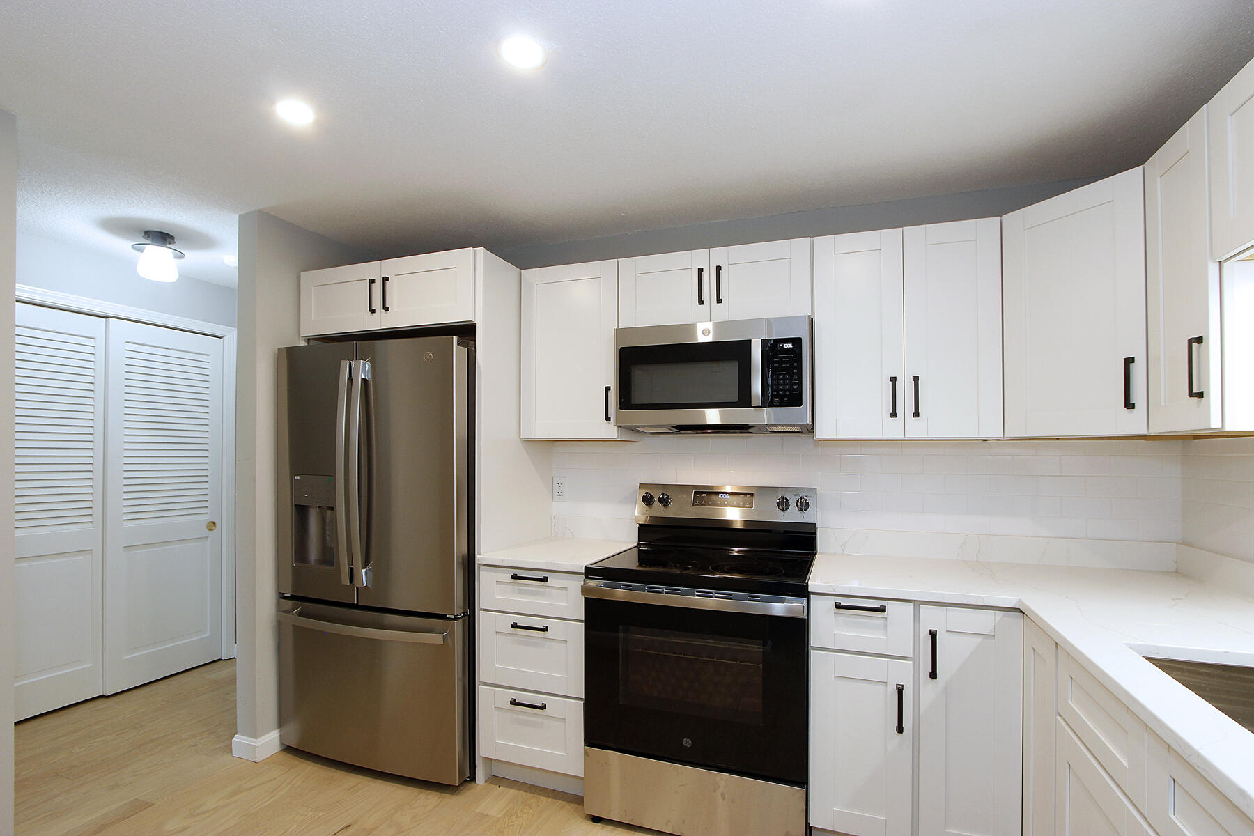 42 Old Colony Way, Unit 30 Orleans, MA 02653 - Photo 3 of 36 a kitchen with white cabinets and stainless steel appliances