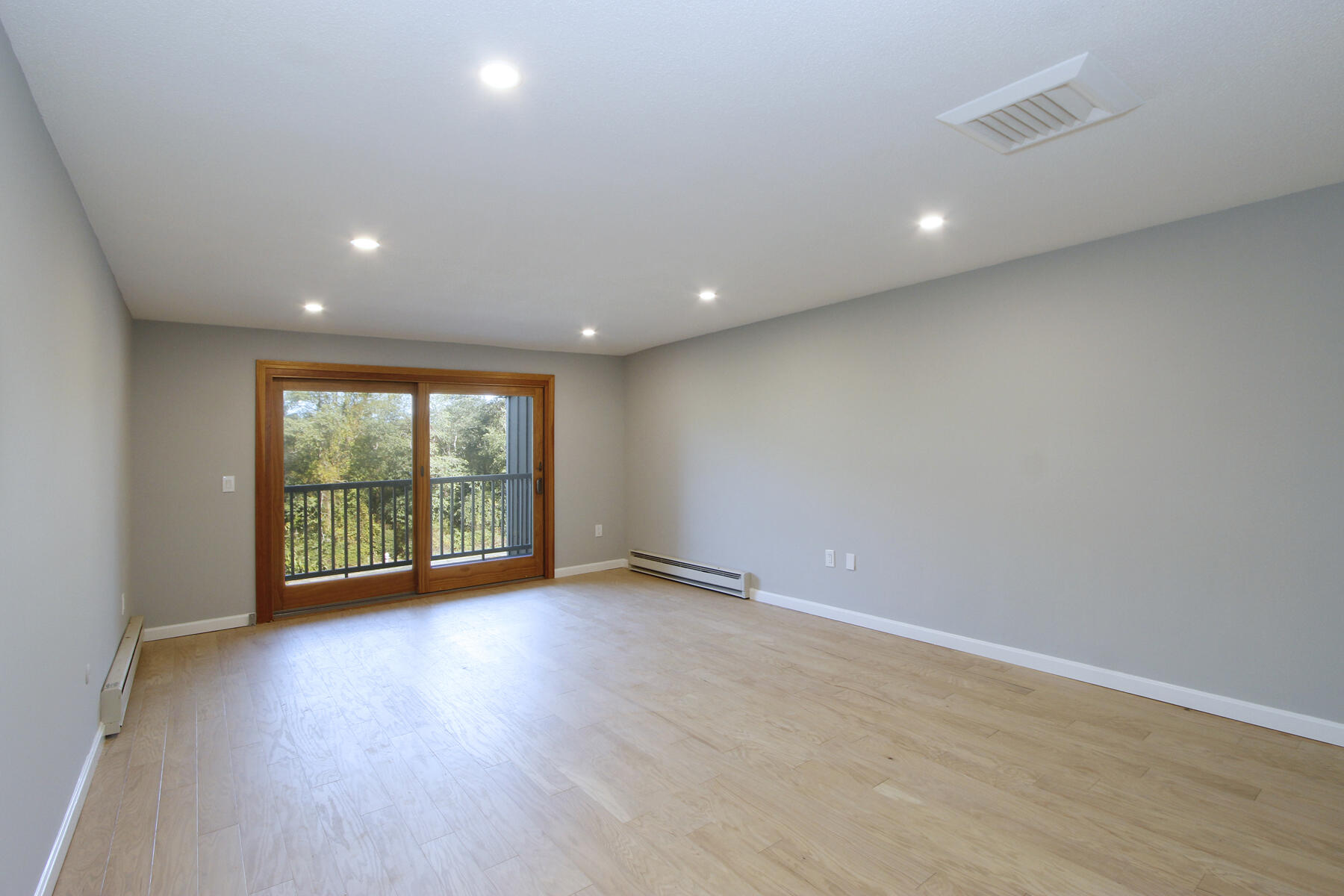 42 Old Colony Way, Unit 30 Orleans, MA 02653 - Photo 6 of 36 a view of an empty room with wooden floor and a window