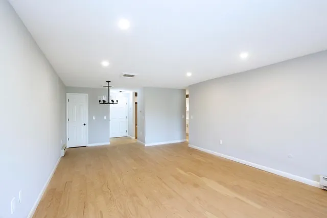 a bathroom with a sink vanity mirror and toilet