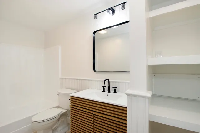 a bathroom with a sink and mirror