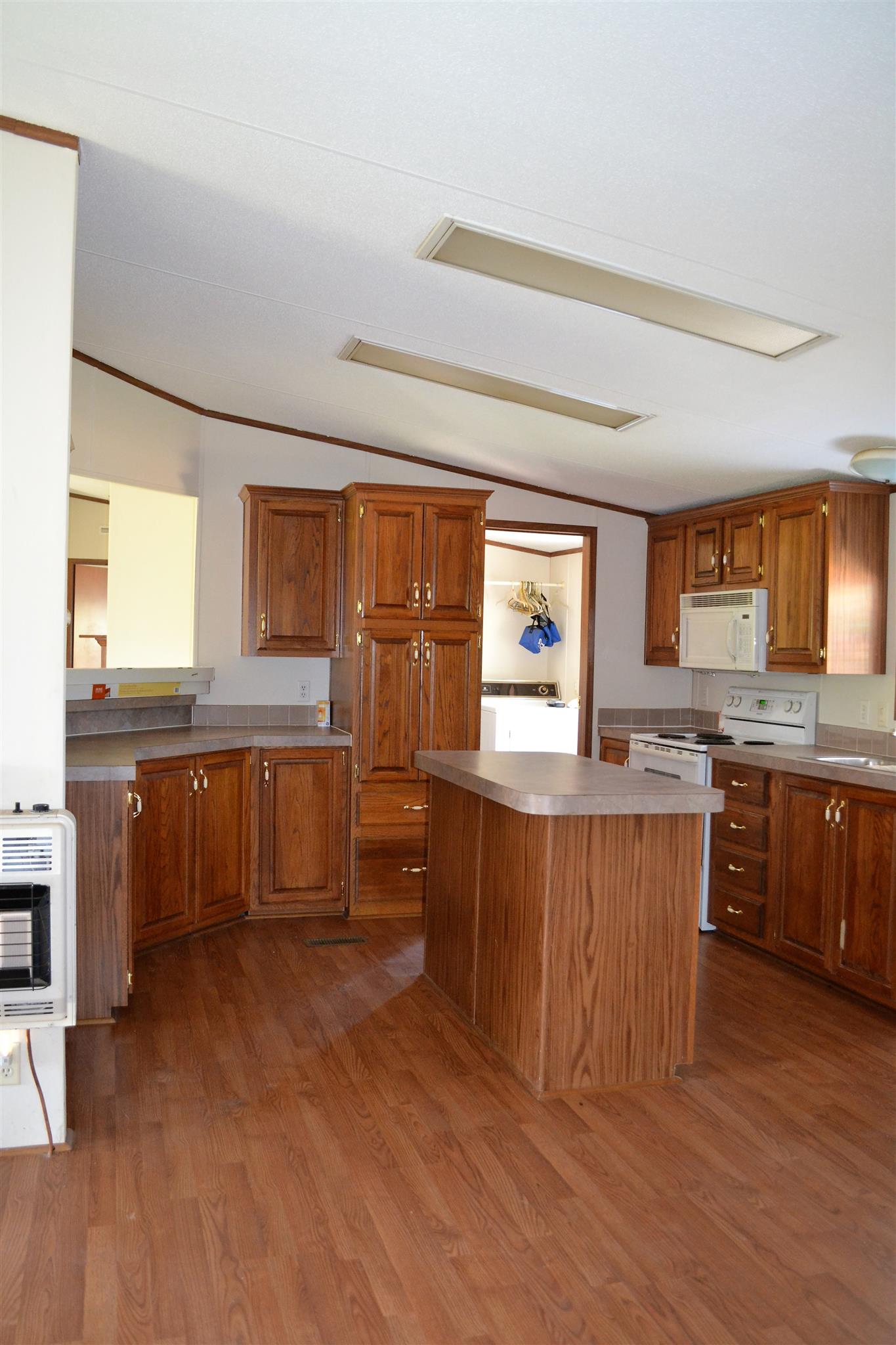 220 Knob Creek Road Lawrenceburg, TN 38464 - Photo 4 of 19 a kitchen with stainless steel appliances kitchen island granite countertop a stove a sink and a refrigerator