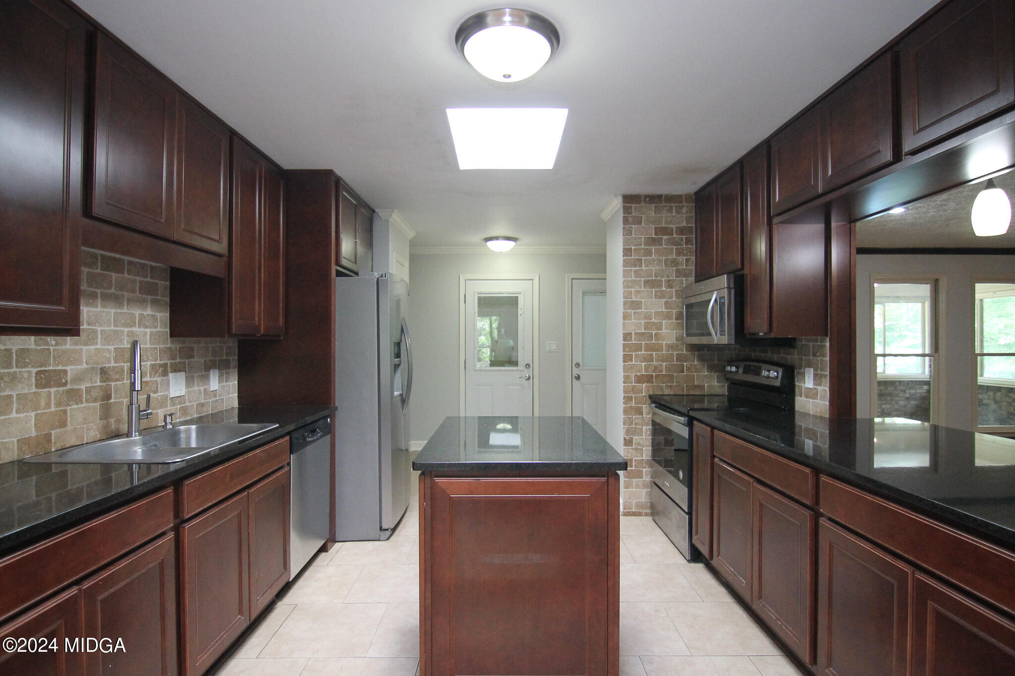102 Nancy Place Bonaire, GA 31005 - Photo 12 of 48 a large kitchen with granite countertop lots of counter space and stainless steel appliances