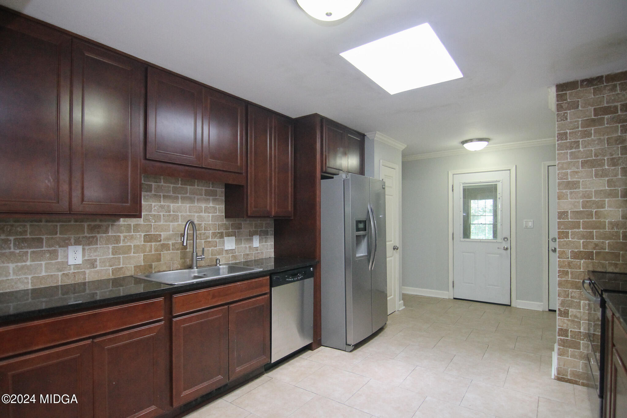 102 Nancy Place Bonaire, GA 31005 - Photo 13 of 48 a kitchen with stainless steel appliances granite countertop wooden cabinets and a refrigerator