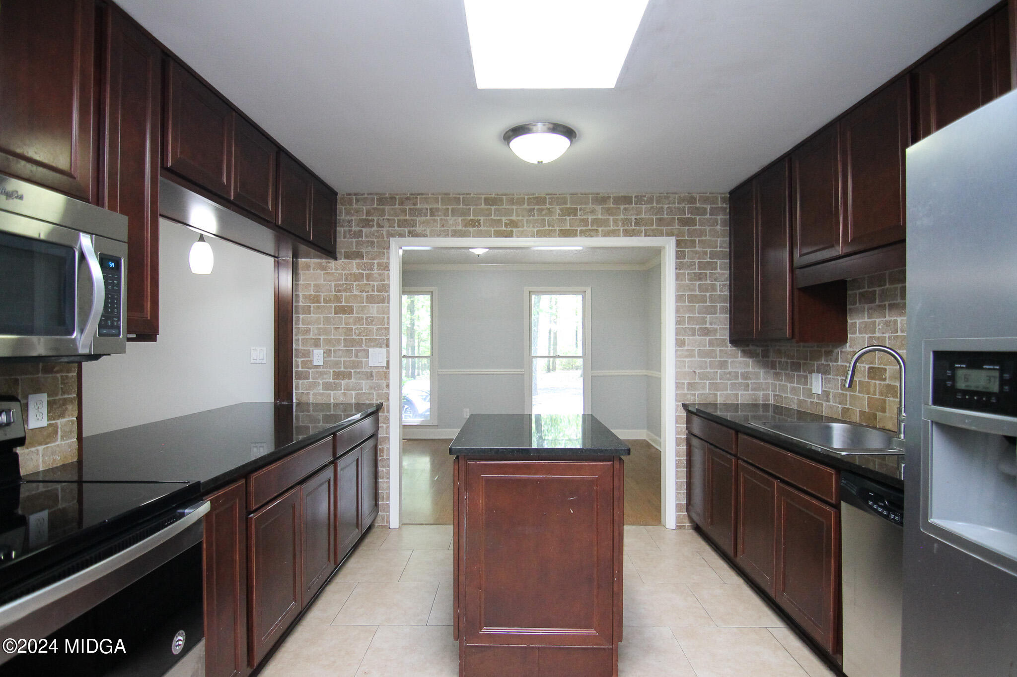 102 Nancy Place Bonaire, GA 31005 - Photo 15 of 48 a kitchen with stainless steel appliances granite countertop a sink stove and refrigerator
