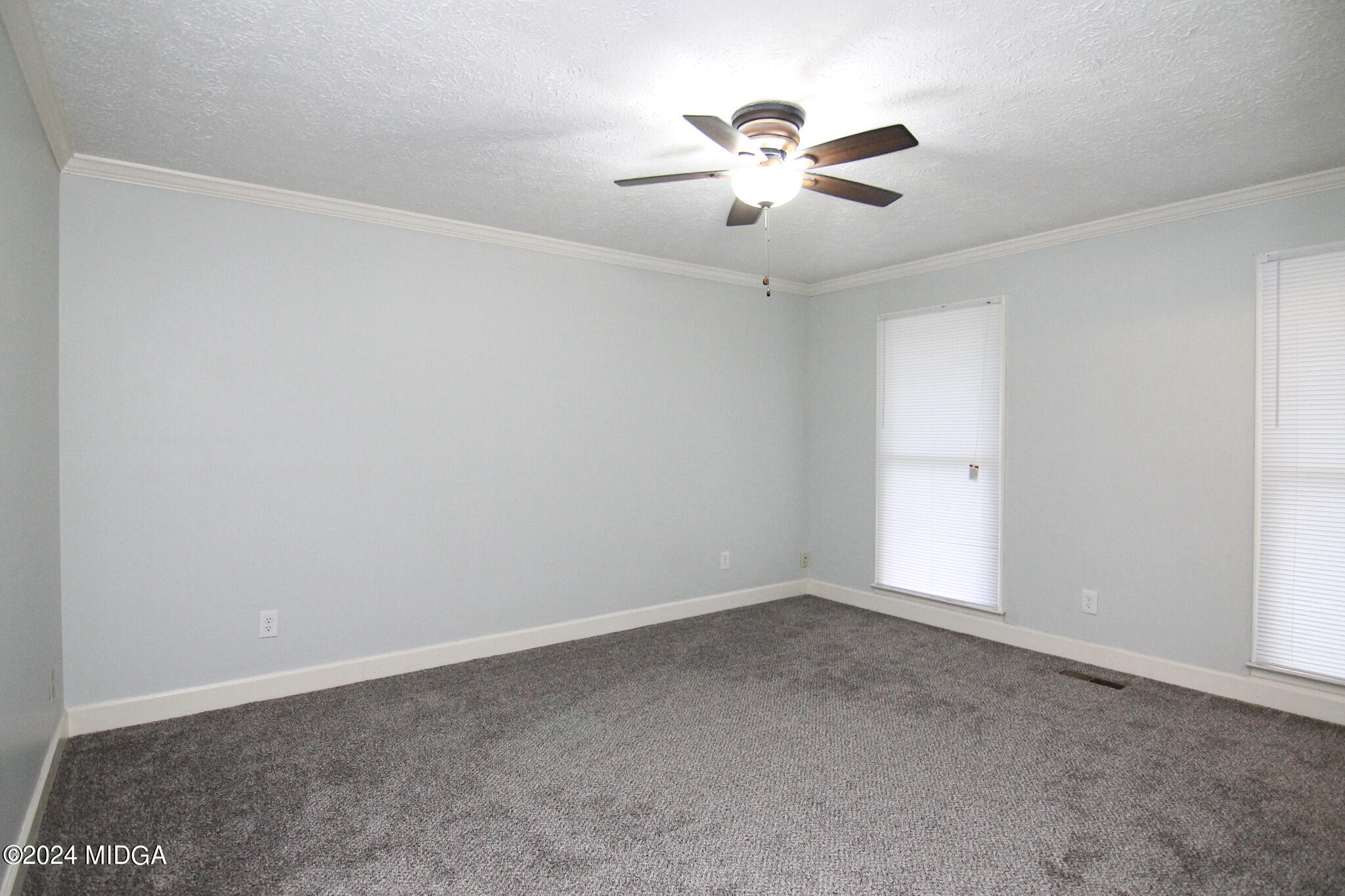 102 Nancy Place Bonaire, GA 31005 - Photo 20 of 48 an empty room with chandelier fan and window