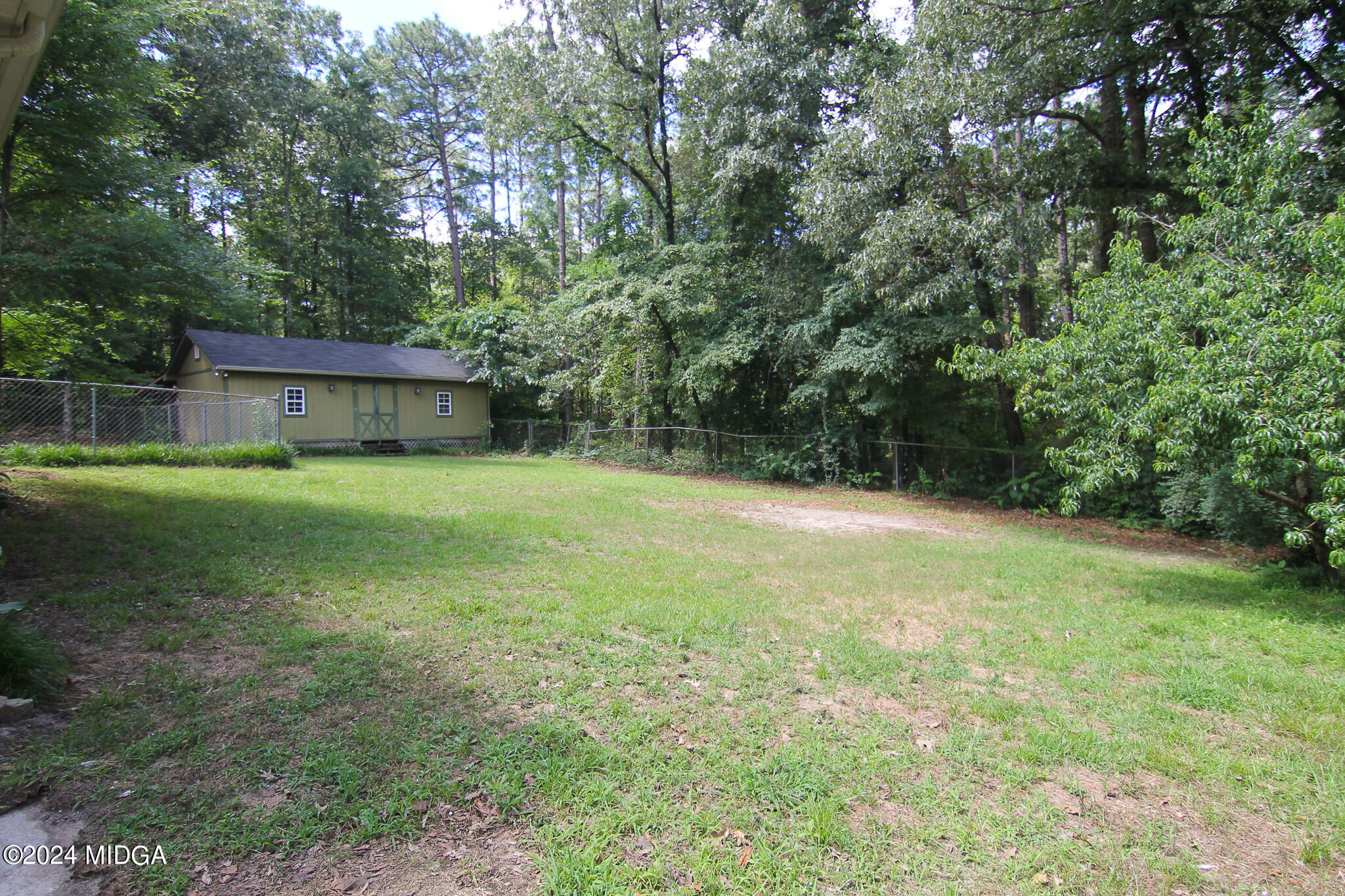 102 Nancy Place Bonaire, GA 31005 - Photo 44 of 48 a view of a backyard with a garden and trees
