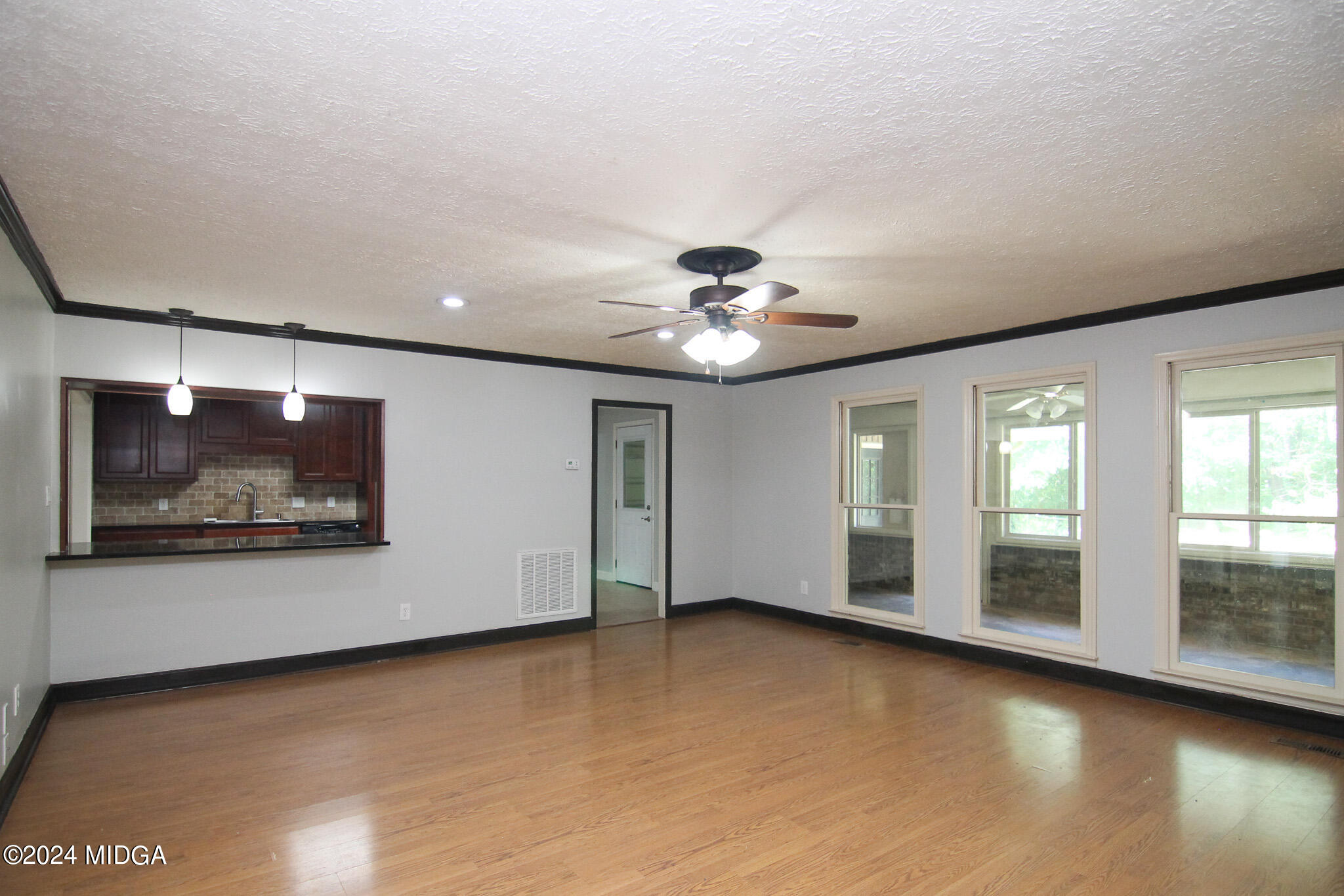 102 Nancy Place Bonaire, GA 31005 - Photo 5 of 48 an empty room with wooden floor and windows