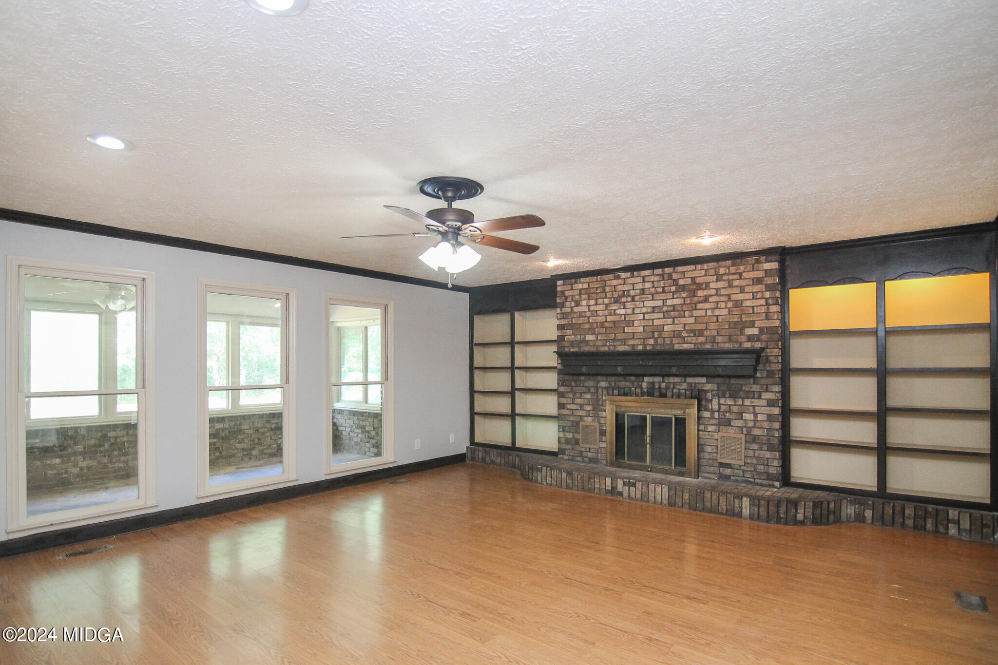 102 Nancy Place Bonaire, GA 31005 - Photo 6 of 48 wooden floor fireplace and windows in an empty room