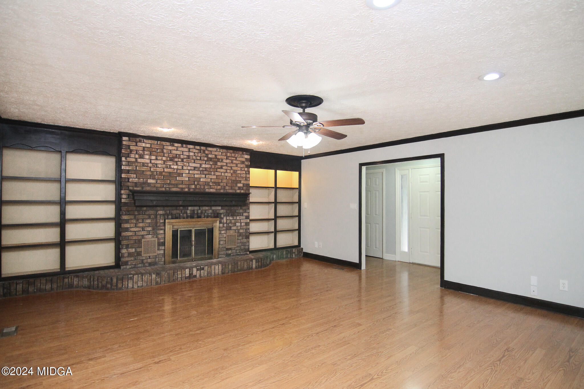 102 Nancy Place Bonaire, GA 31005 - Photo 7 of 48 a view of an empty room with a fireplace and a window