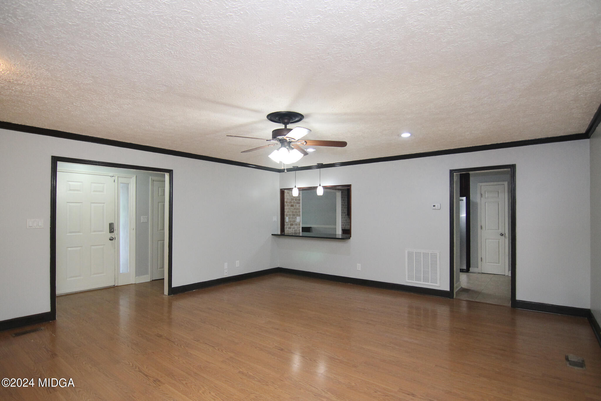 102 Nancy Place Bonaire, GA 31005 - Photo 8 of 48 an empty room with wooden floor chandelier fan and windows