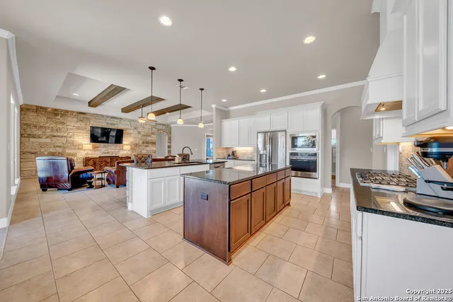 a large kitchen with stainless steel appliances lots of counter top space