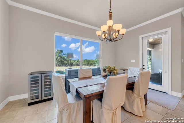 a view of a dining room with furniture wooden floor and chandelier