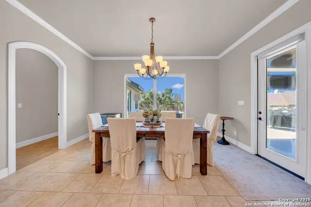 a dining room with furniture a chandelier and a rug