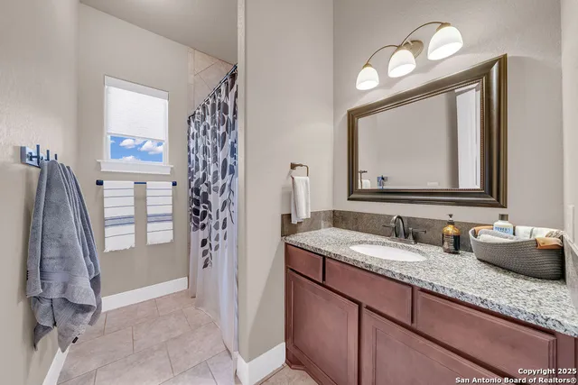 a bathroom with a double vanity sink and a mirror
