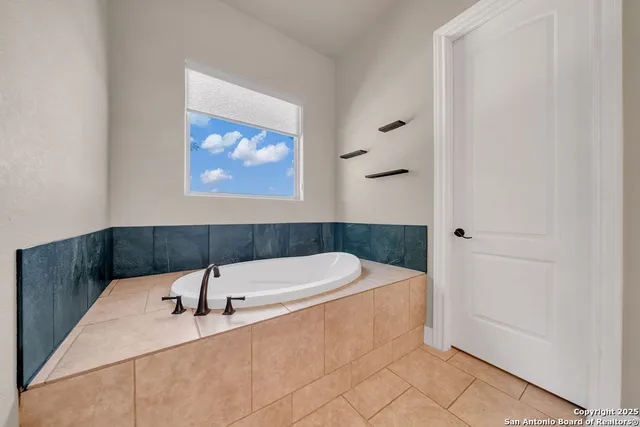 a bathroom with a tub and a shower