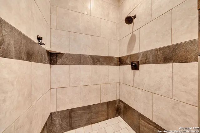a bathroom with a shower and a shower