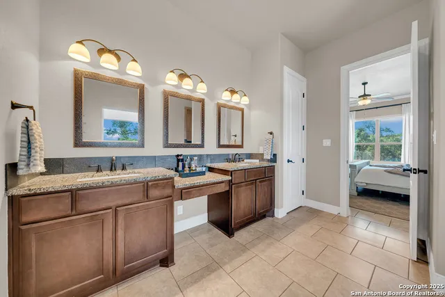 a large bathroom with a large tub sink and mirror