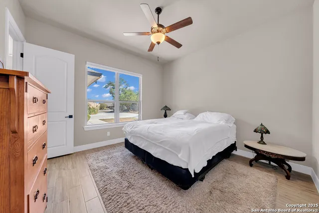 a spacious bedroom with a bed and a window