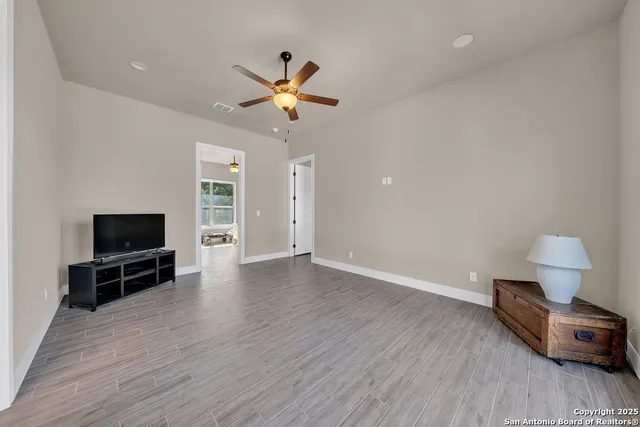 a view of livingroom with hardwood floor and a ceiling fan
