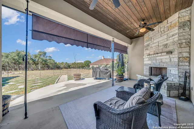 a balcony with furniture and a fireplace