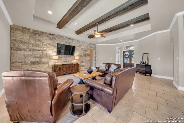 a living room with furniture a flat screen tv and a fireplace