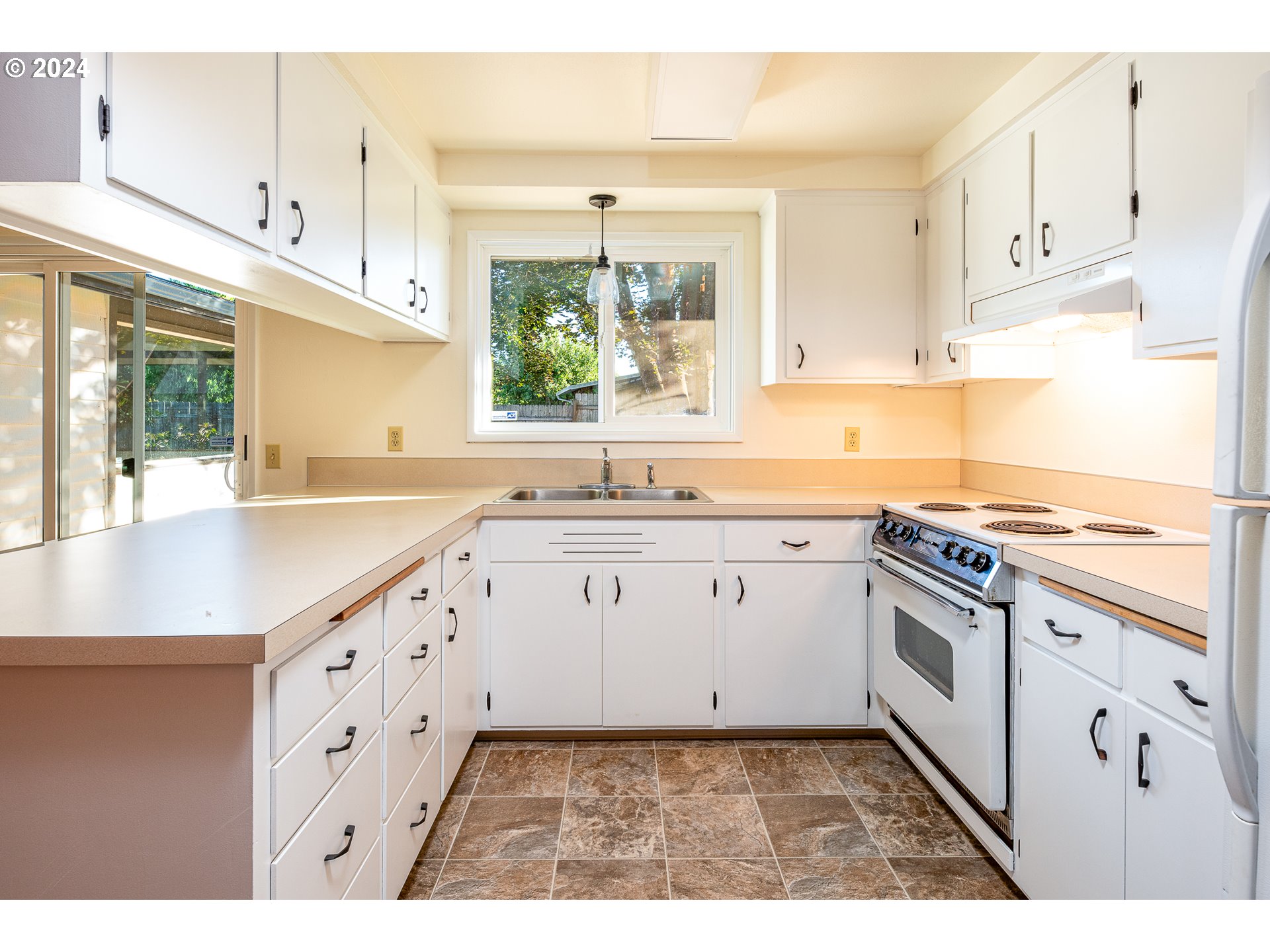 3726 Jasper Road Springfield, OR 97478 - Photo 8 of 45 a kitchen with granite countertop white cabinets and white appliances