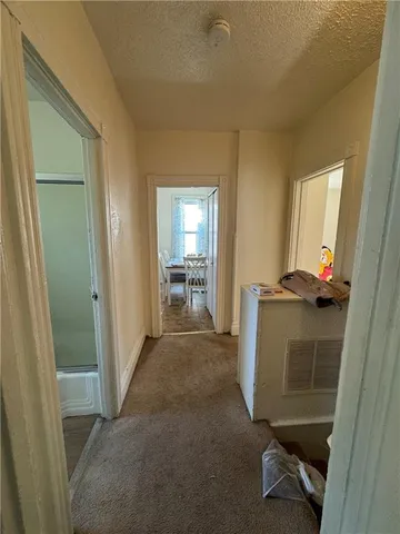 a view of hallway with livingroom and furniture